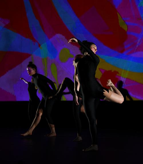  Dancer in front of a dark purle background