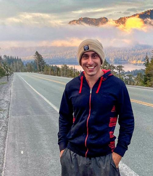  Person standing by a road with mountains in the background