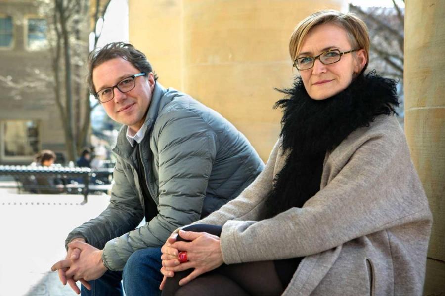 Two people sitting in front of pillars