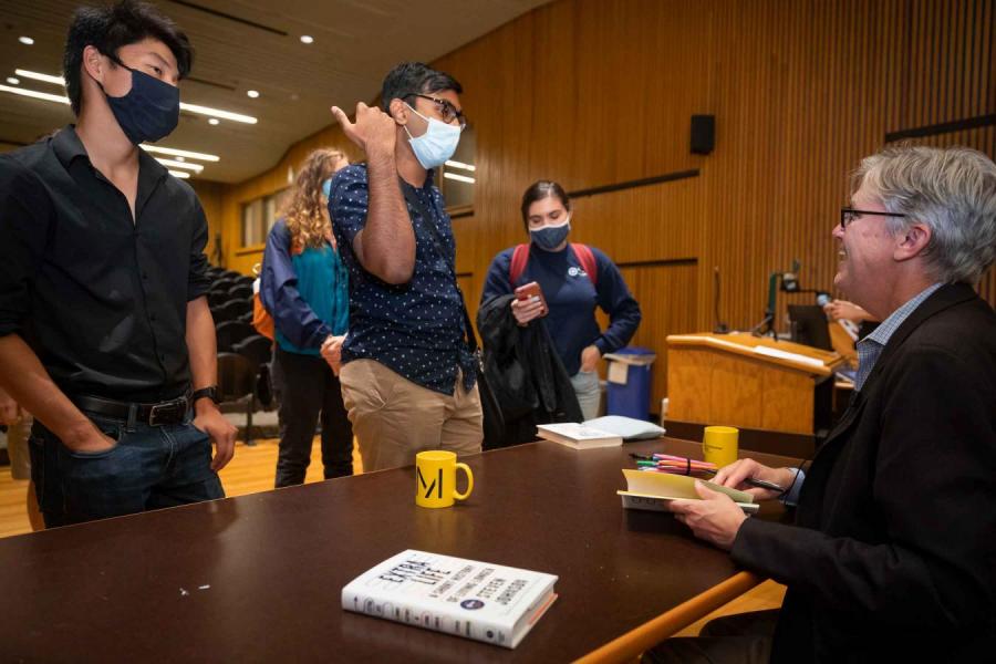 person and table signing books