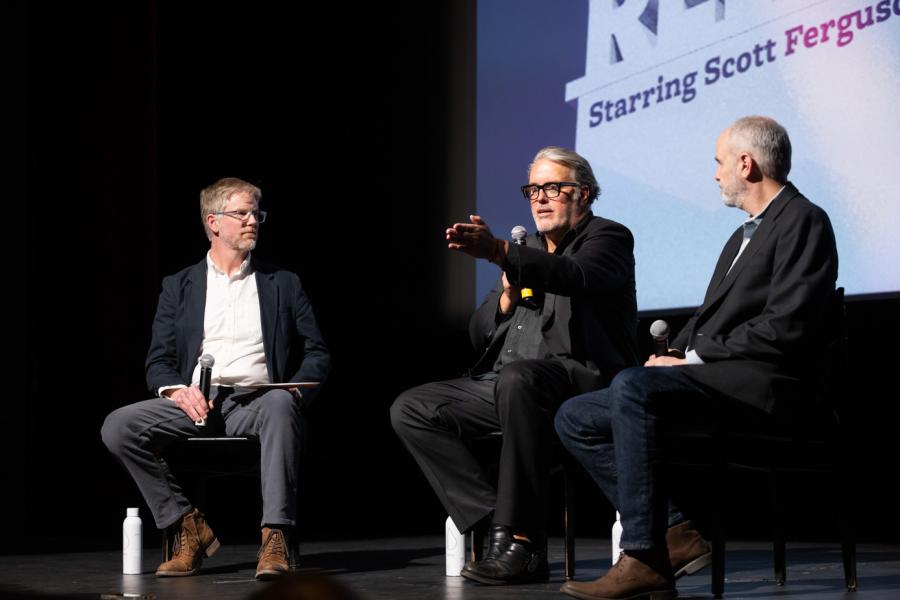 three men on stage