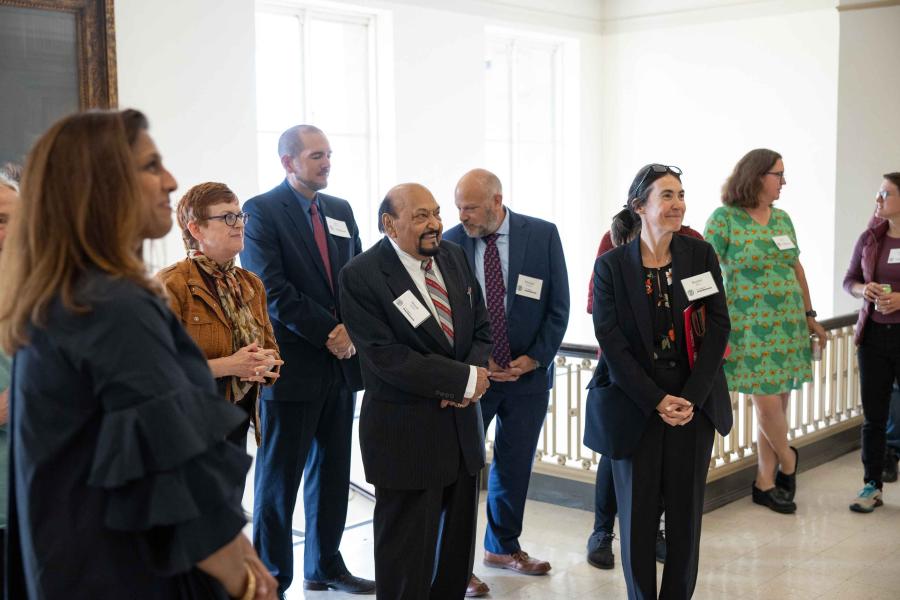 A group of 10 people looking at something