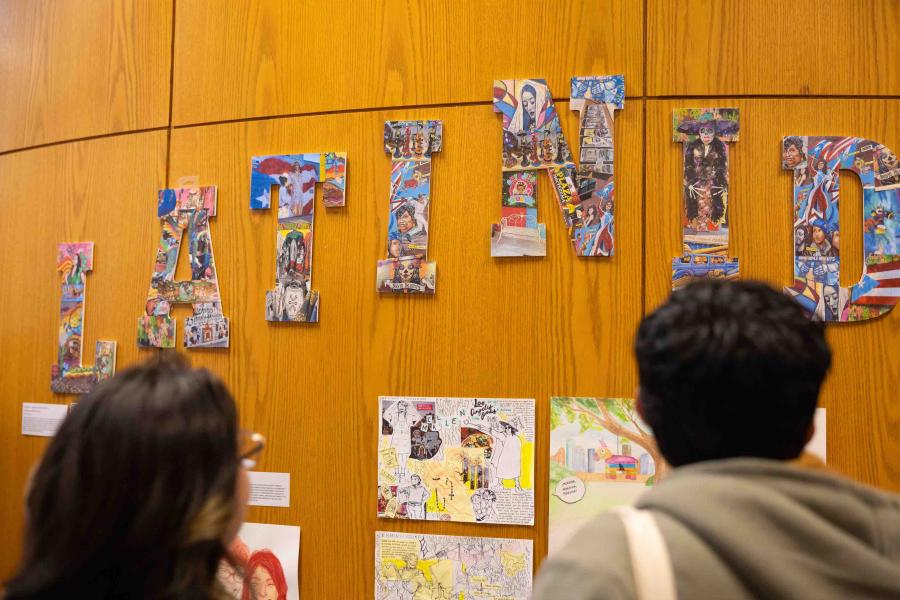 students looking at Latinidad letters collaged with photos