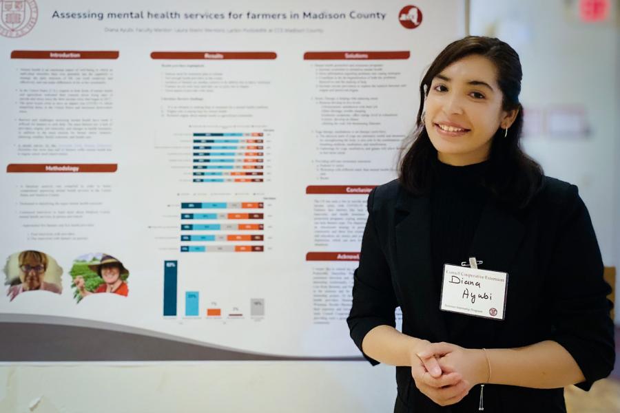 person standing near research poster
