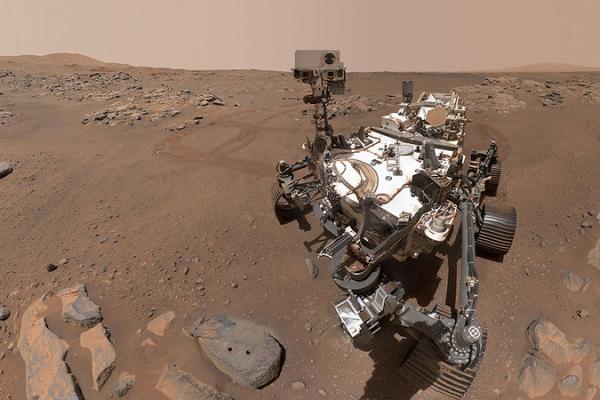 Metal machine with wheels on a rocky landscape