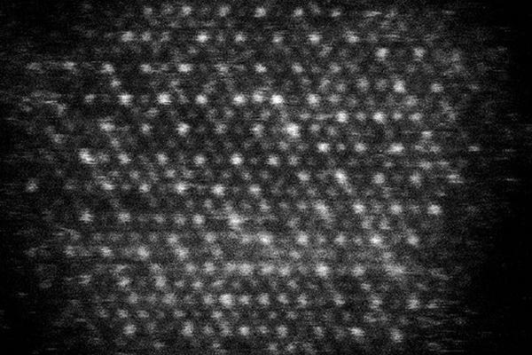 Dark background with a pattern of white dots in diagonal lines