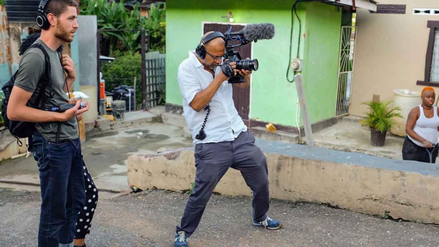 man with video camera and another man with headphones