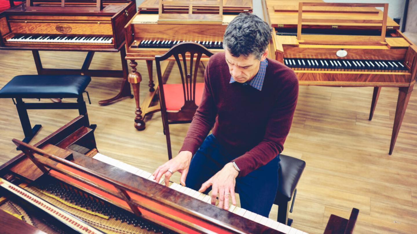 Person playing a keyboard instrument, seen from above